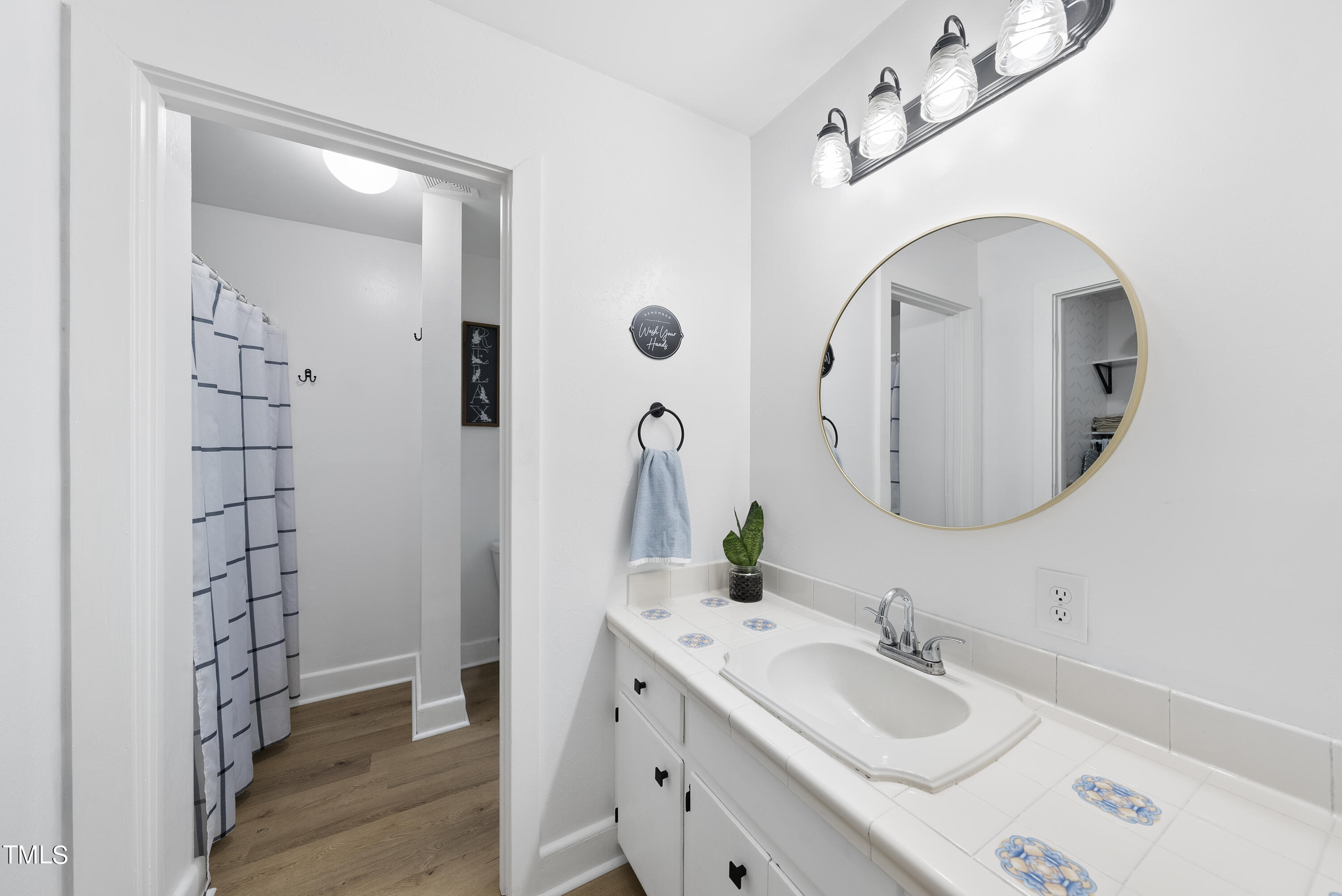 6319 Carbonton Road Sanford, NC 27330 - Photo 10 of 19 a bathroom with a double vanity sink and a mirror