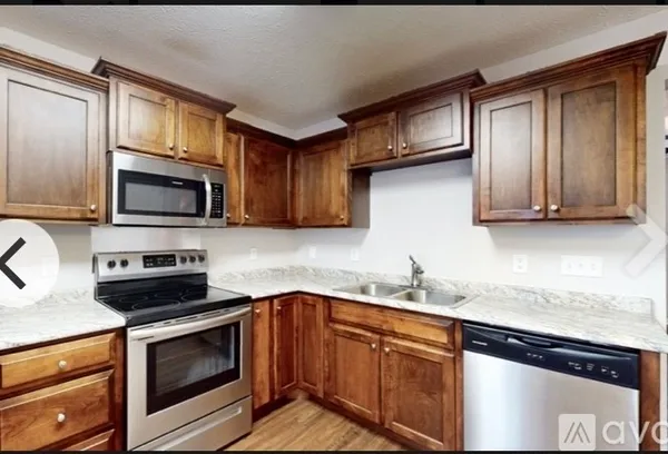 a kitchen with stainless steel appliances granite countertop a sink stove microwave and cabinets