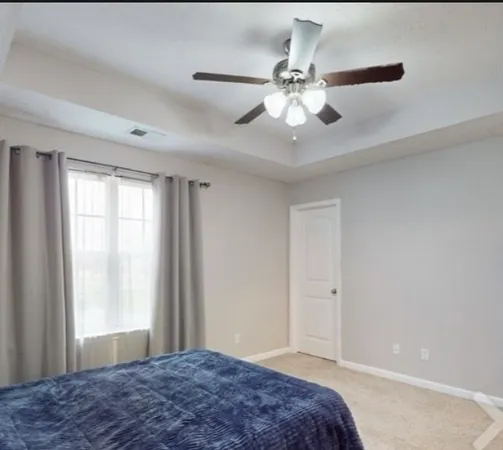 a bedroom with a large bed and a window