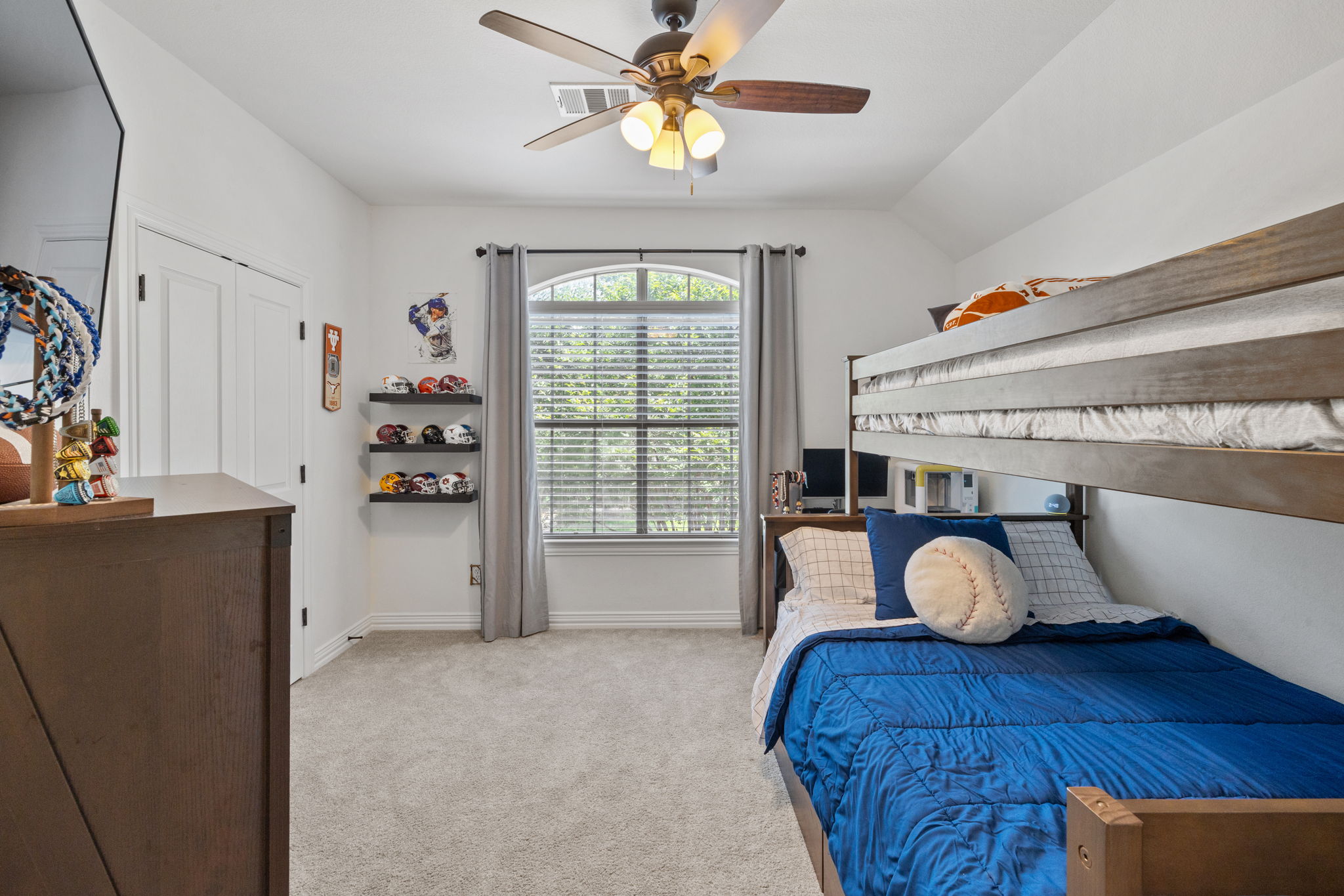 1124 Castle Path Round Rock, TX 78681 - Photo 28 of 40 A well-lit bedroom with vaulted ceilings and soft gray carpet, featuring a window and bunk beds.
