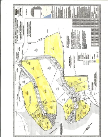a view of a street with a big yard and large trees