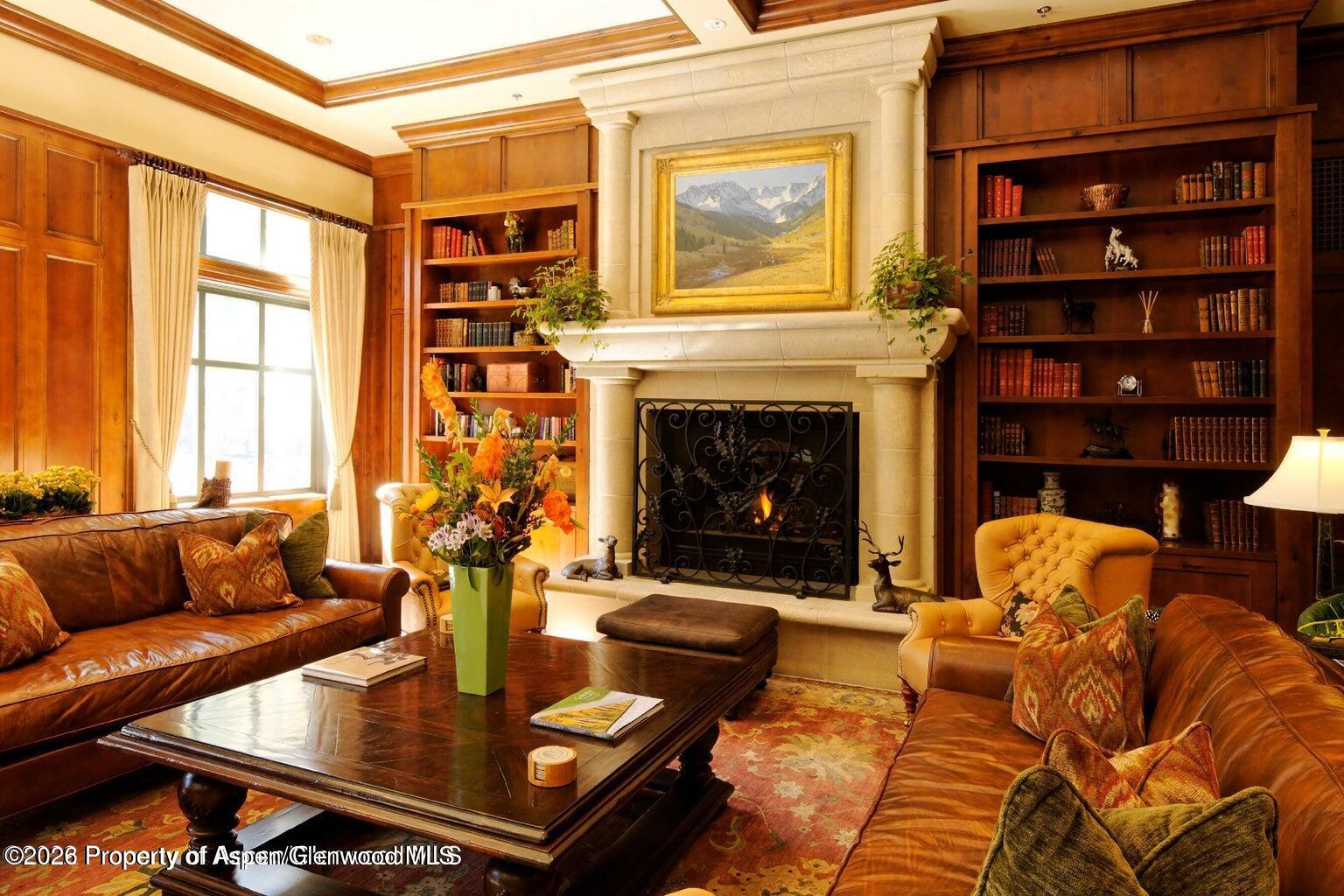 39 Boomerang Road, Unit 83119 Aspen, CO 81611 - Photo 8 of 16 a living room with furniture fireplace and a large window