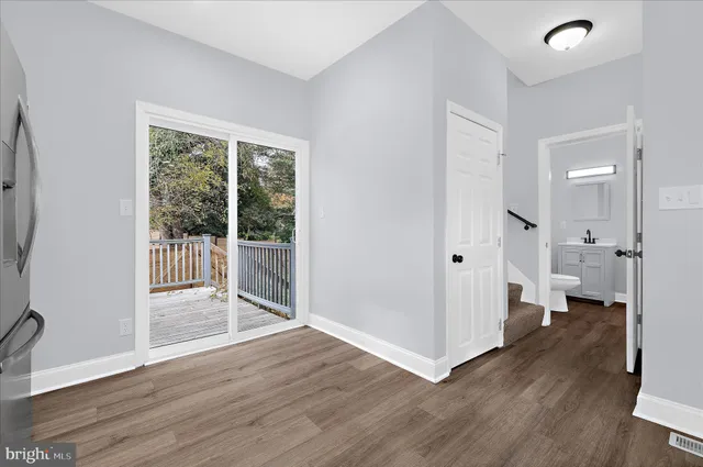 a view of a entrance and room with wooden floor