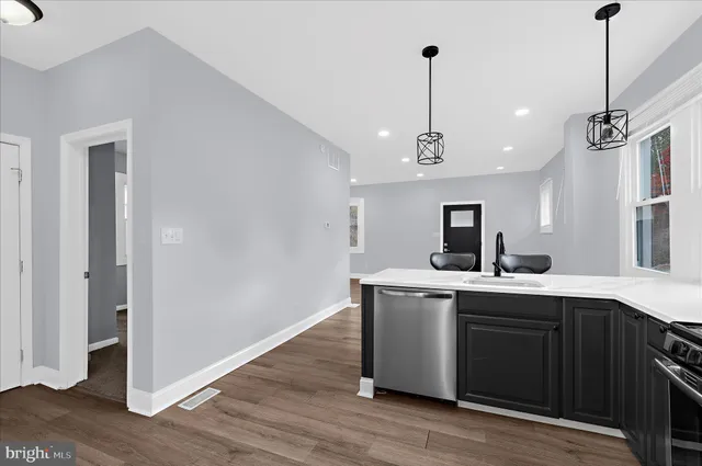 a view of a room with wooden floor and furniture