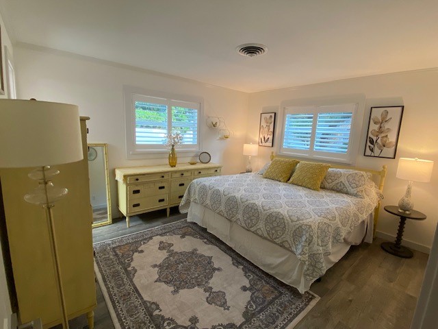 3816 Mockingbird Drive Vero Beach, FL 32963 - Photo 12 of 19 a bedroom with a bed dresser and window
