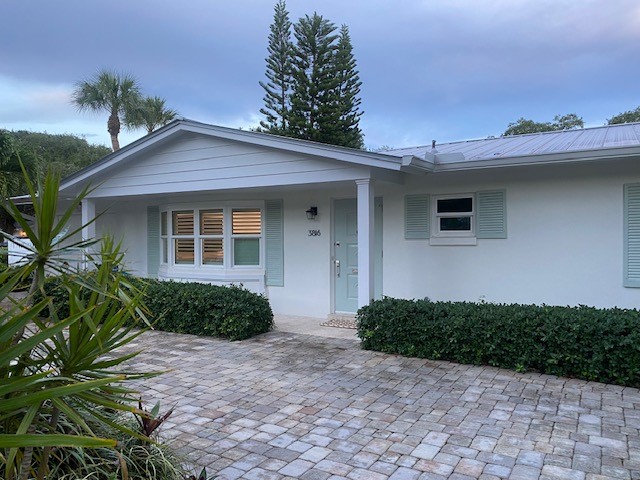 3816 Mockingbird Drive Vero Beach, FL 32963 - Photo 2 of 19 a front view of a house with garden