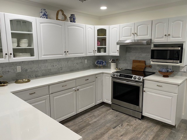 3816 Mockingbird Drive Vero Beach, FL 32963 - Photo 5 of 19 a kitchen with granite countertop a sink cabinets and stainless steel appliances