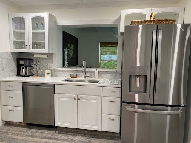 3816 Mockingbird Drive Vero Beach, FL 32963 - Photo 7 of 19 a kitchen with stainless steel appliances and refrigerator