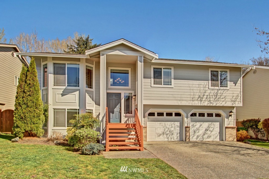 24219 13th Place West Bothell, WA 98021 - Photo 1 of 18 a front view of a house with a yard