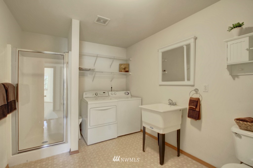 24219 13th Place West Bothell, WA 98021 - Photo 18 of 18 a bathroom with a sink a toilet and a mirror