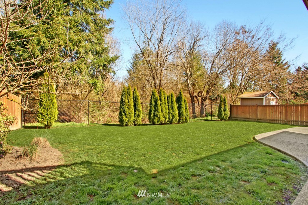 24219 13th Place West Bothell, WA 98021 - Photo 4 of 18 a view of a backyard with large trees