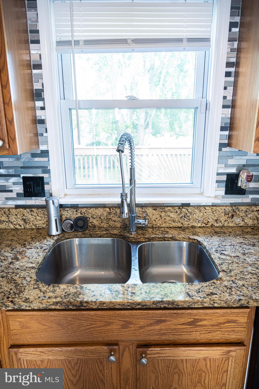 3115 Northmont Road Windsor Mill, MD 21244 - Photo 11 of 49 a view of kitchen sink a granite counter top a sink and cabinets