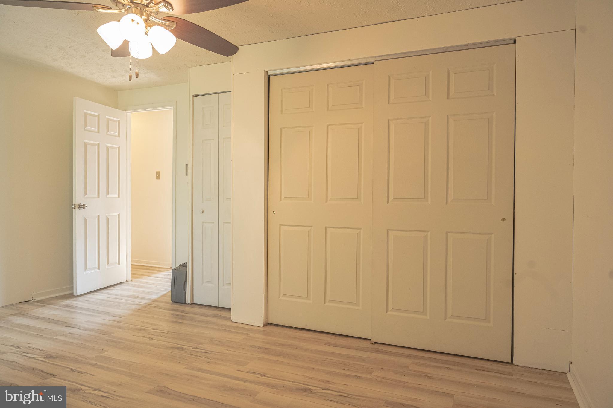 3115 Northmont Road Windsor Mill, MD 21244 - Photo 19 of 49 an empty room with wooden floor fan and windows