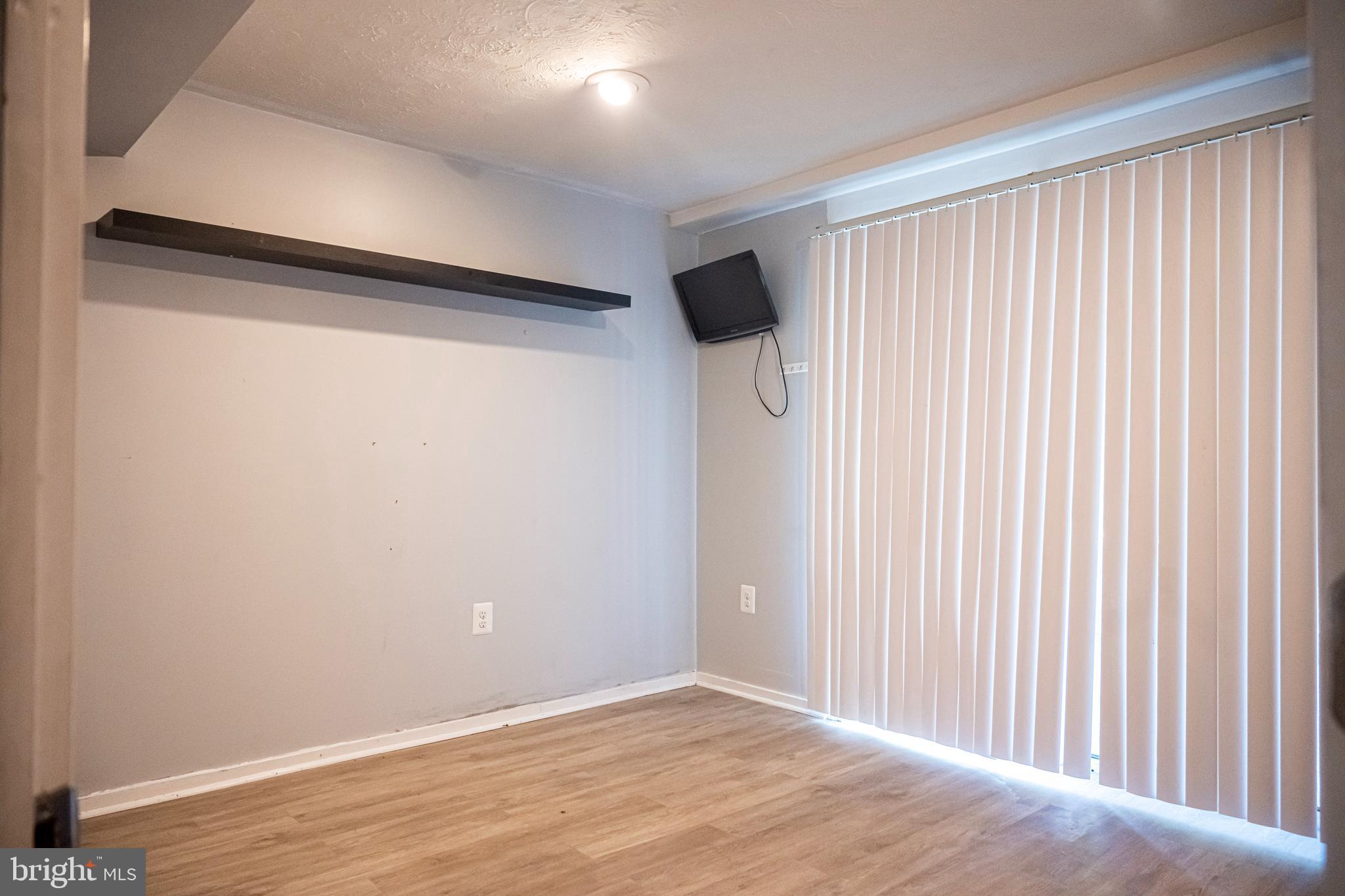 3115 Northmont Road Windsor Mill, MD 21244 - Photo 23 of 49 a view of an empty room with wooden floor