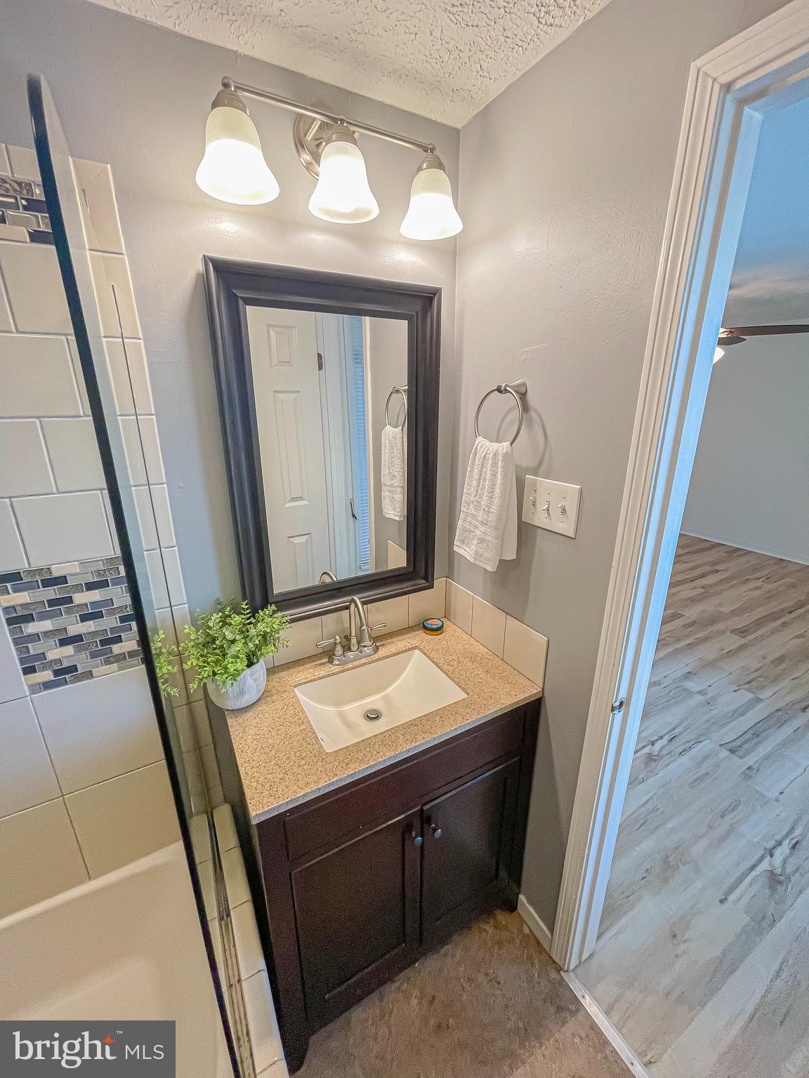 3115 Northmont Road Windsor Mill, MD 21244 - Photo 30 of 49 a bathroom with a sink a mirror and vanity