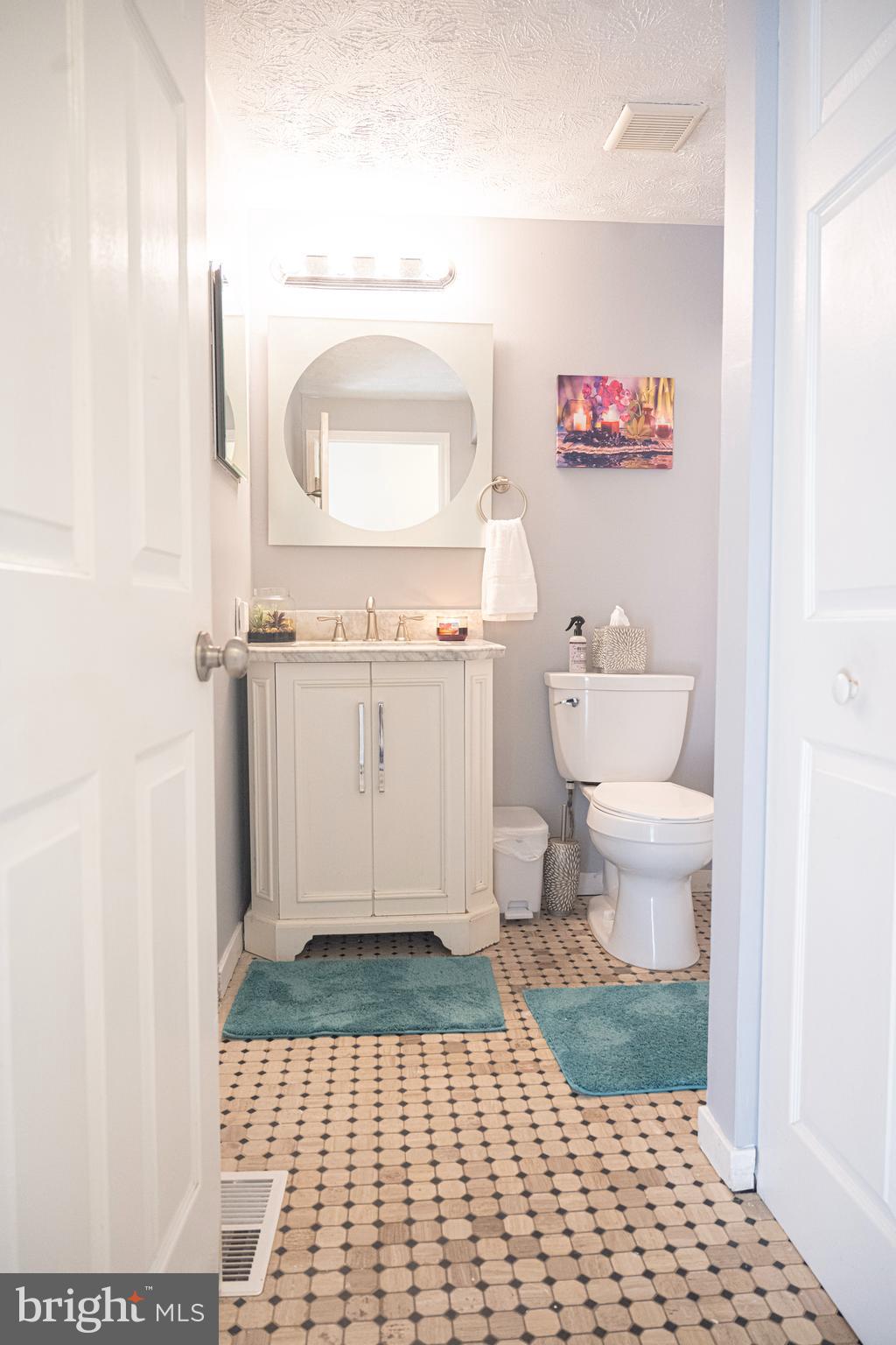 3115 Northmont Road Windsor Mill, MD 21244 - Photo 34 of 49 a bathroom with a sink a toilet a mirror and vanity