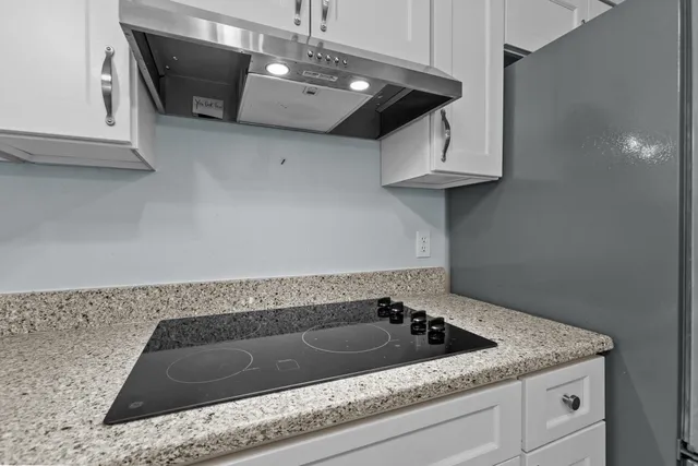 a kitchen with cabinets stainless steel appliances a sink and a window