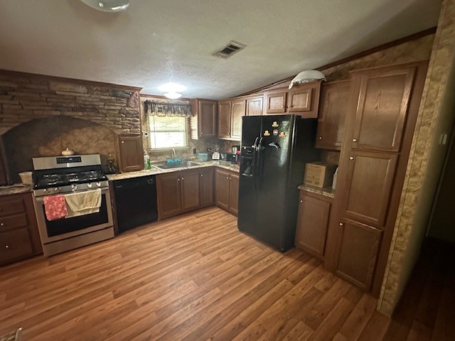 6083 Farm To Market 1462 Rosharon, TX 77583 - Photo 32 of 43 a kitchen with stainless steel appliances granite countertop a refrigerator a sink and wooden cabinets