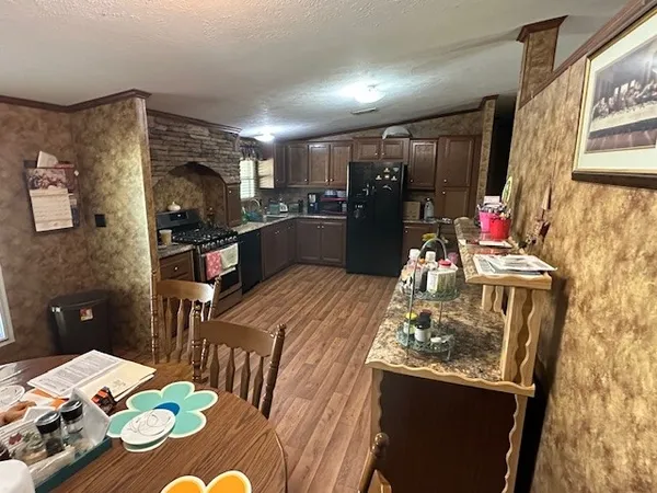 a large kitchen with lots of counter top space and stainless steel appliances