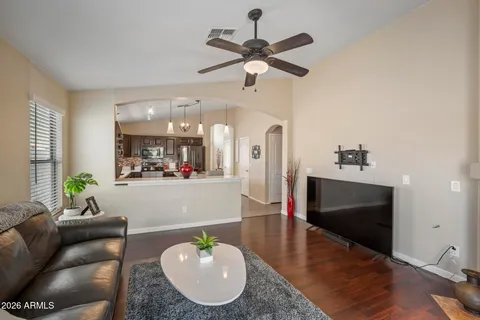 a living room with furniture and a wooden floor