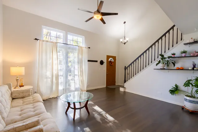 a living room with furniture and a chandelier