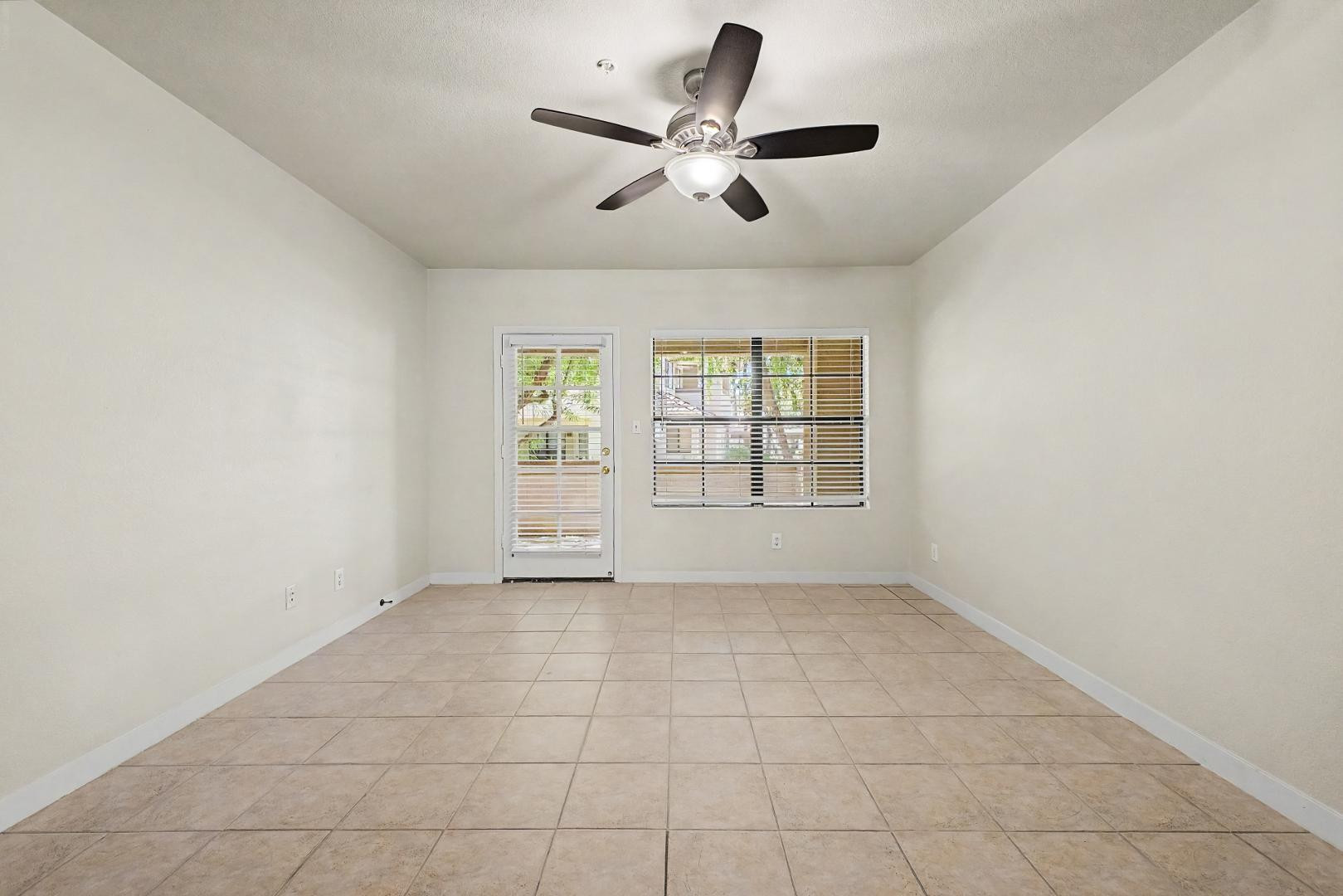 6885 East Cochise Road, Unit 142 Paradise Valley, AZ 85253 - Photo 20 of 47 an empty room with windows and ceiling fan