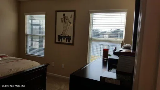 a view of a livingroom with furniture and a window