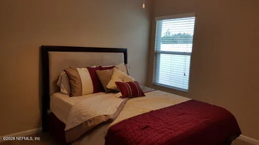 a bedroom with a bed and window