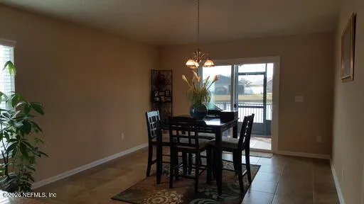 a view of a dining room with furniture and window