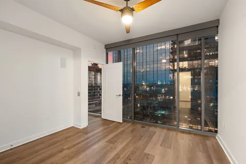 a view of empty room with window and front door
