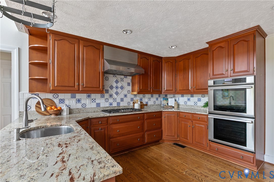 10000 Ramsbury Way Richmond, VA 23238 - Photo 21 of 59 a kitchen with stainless steel appliances granite countertop a sink stove and cabinets