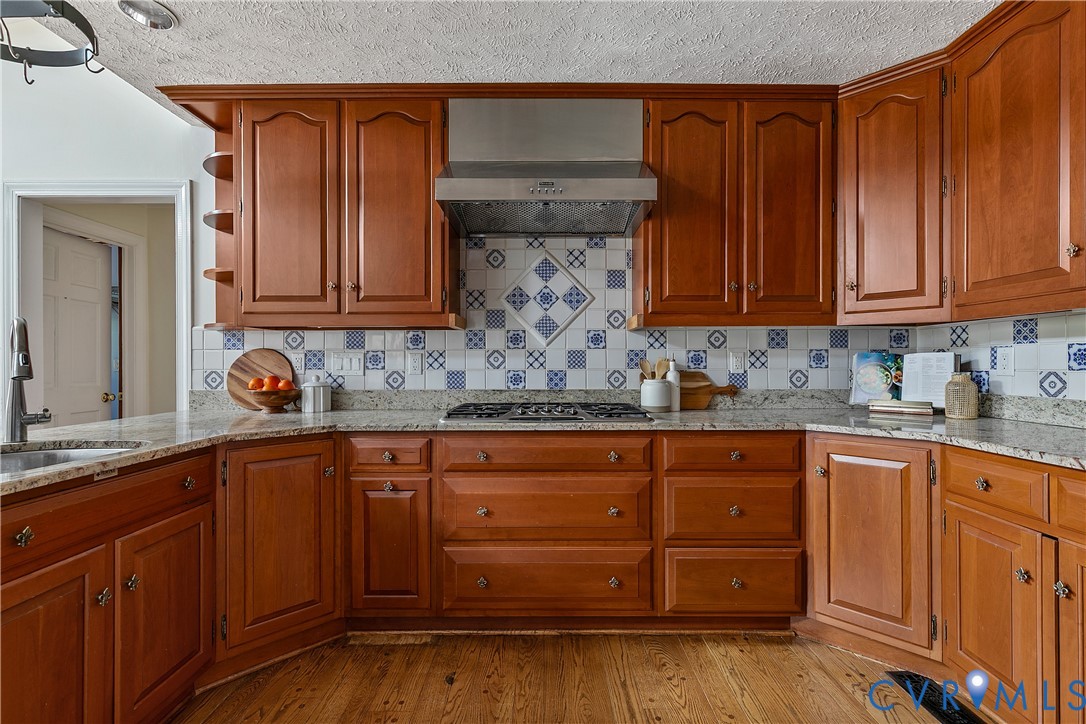 10000 Ramsbury Way Richmond, VA 23238 - Photo 22 of 59 a kitchen with stainless steel appliances granite countertop wooden cabinets and a sink