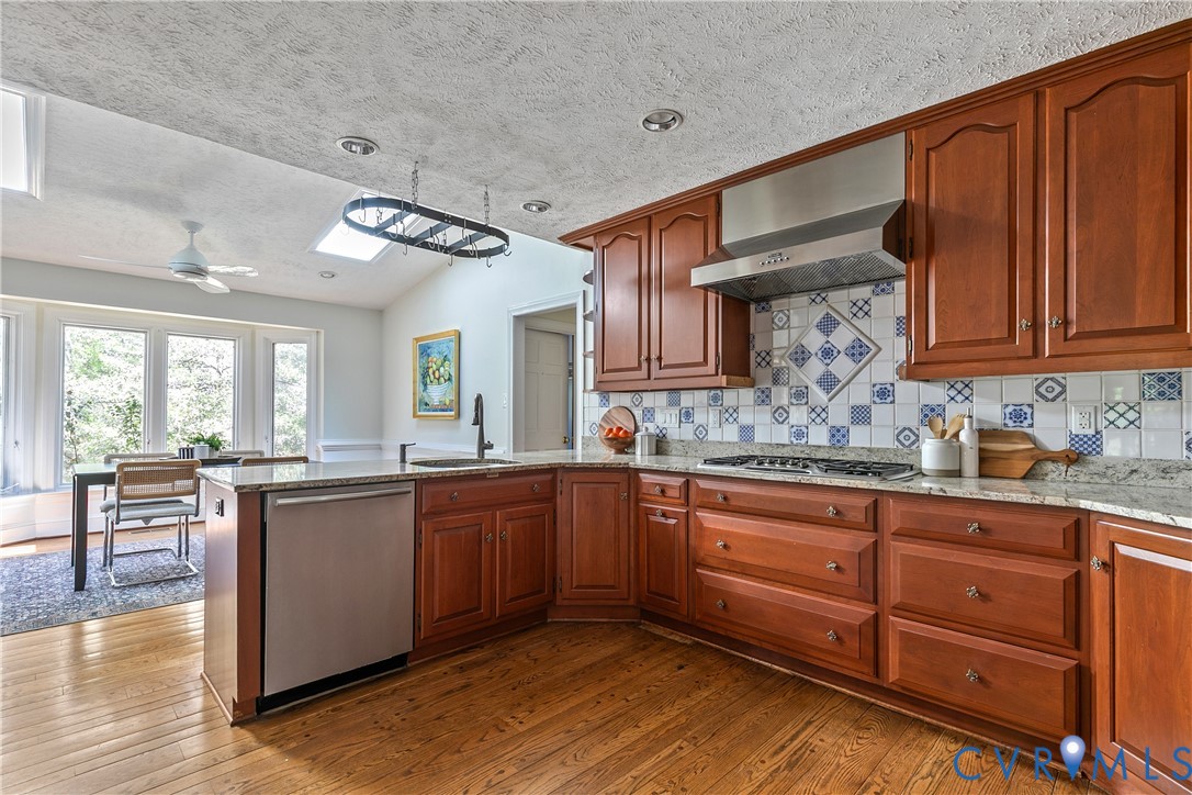 10000 Ramsbury Way Richmond, VA 23238 - Photo 23 of 59 a kitchen with granite countertop wooden cabinets a sink and dishwasher