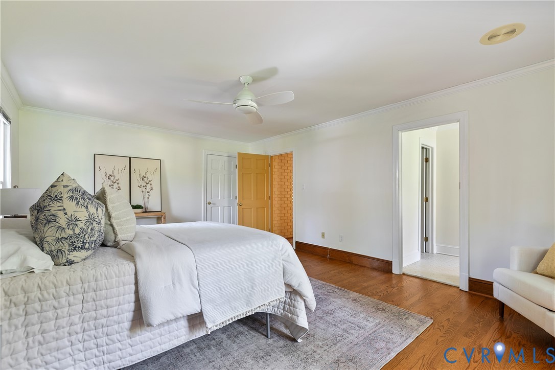 10000 Ramsbury Way Richmond, VA 23238 - Photo 32 of 59 a bedroom with a large bed and wooden floor
