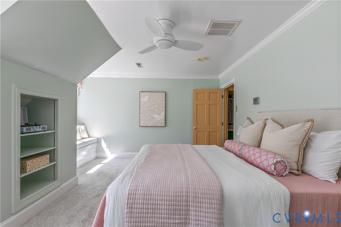 10000 Ramsbury Way Richmond, VA 23238 - Photo 41 of 59 a bedroom with a large bed and a chandelier