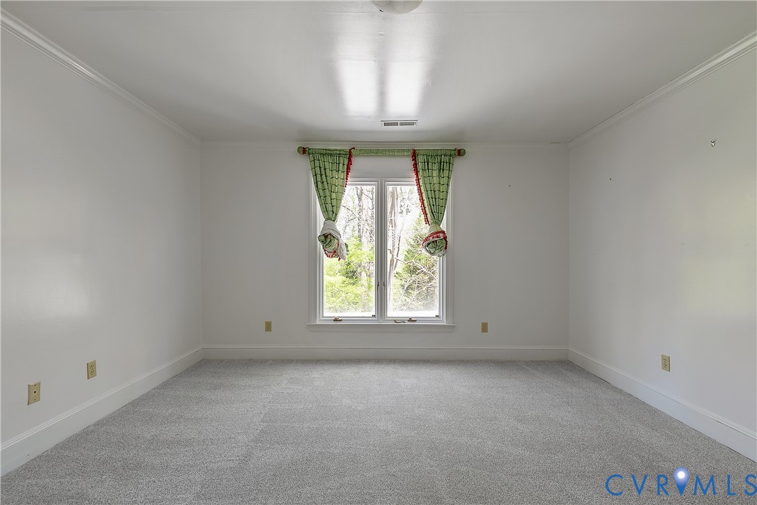10000 Ramsbury Way Richmond, VA 23238 - Photo 45 of 59 an empty room with a chandelier fan and windows