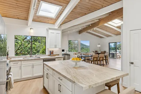 a dining room with furniture window and wooden floor