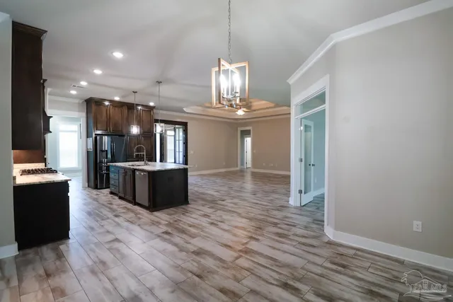 a view of a kitchen with sink and wooden floor
