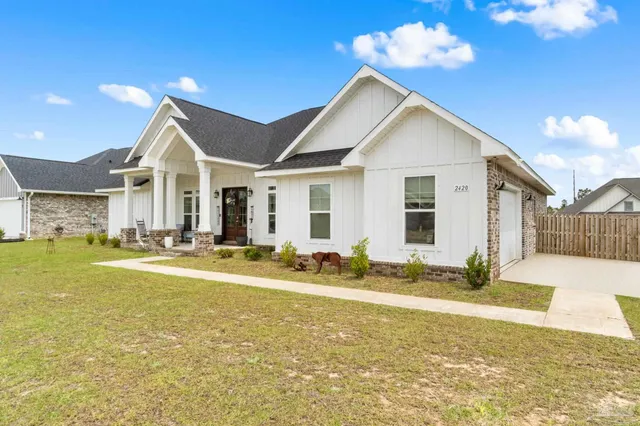 a view of a house with swimming pool and a yard