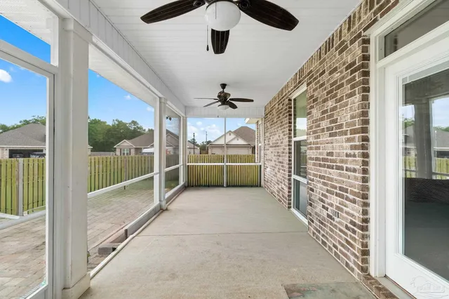 a view of a house with a yard and wooden fence