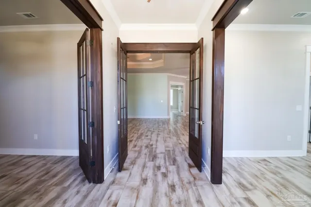 a view of a hallway with wooden floor and closet