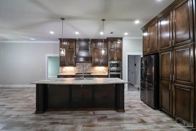 a kitchen with stainless steel appliances granite countertop a sink stove and refrigerator