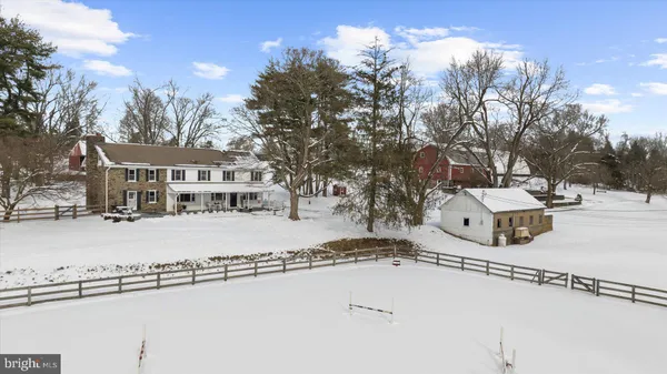 a view of a house with a yard covered in snow