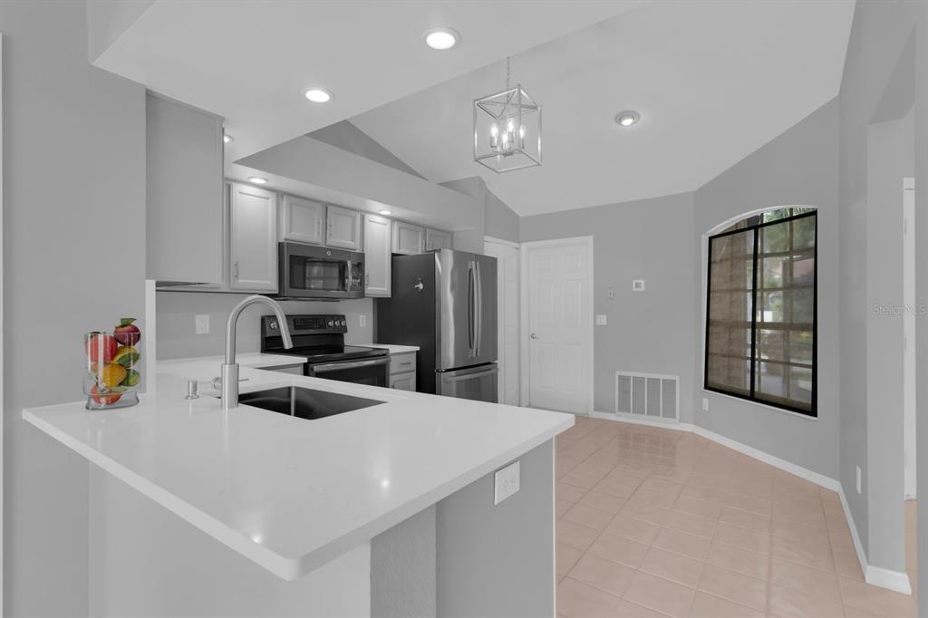 625 Nighthawk Circle Winter Springs, FL 32708 - Photo 28 of 36 a kitchen that has a lot of cabinets a sink and appliances