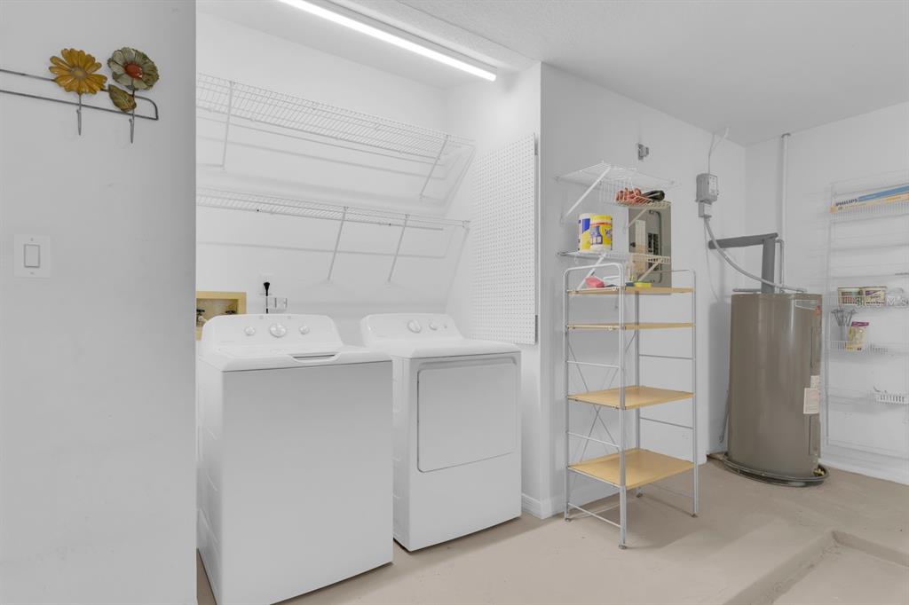 625 Nighthawk Circle Winter Springs, FL 32708 - Photo 32 of 36 a utility room with cabinets washer and dryer