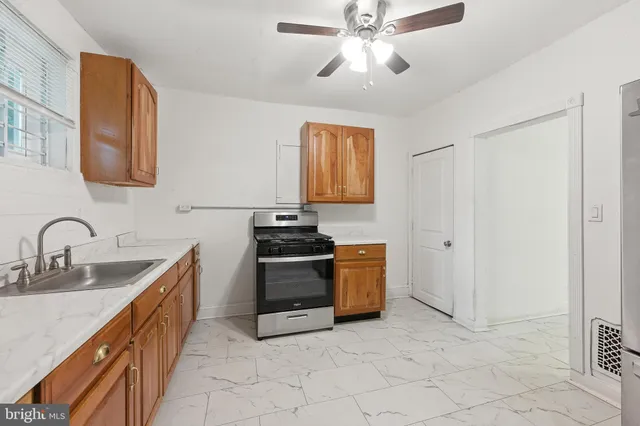 a kitchen with stainless steel appliances granite countertop a sink and cabinets