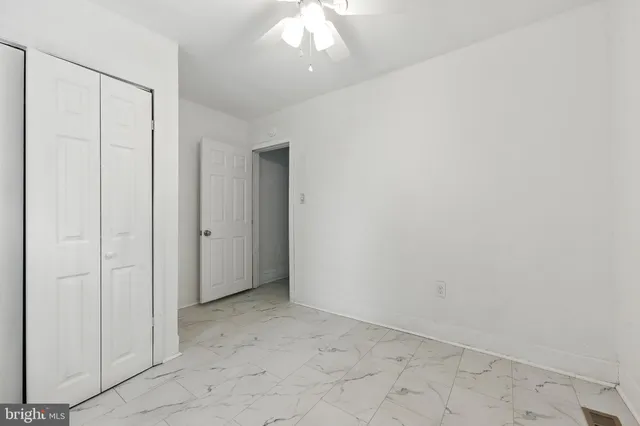 an empty room with a ceiling fan