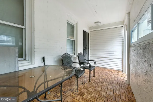 a view of a tables and chairs in back of the house