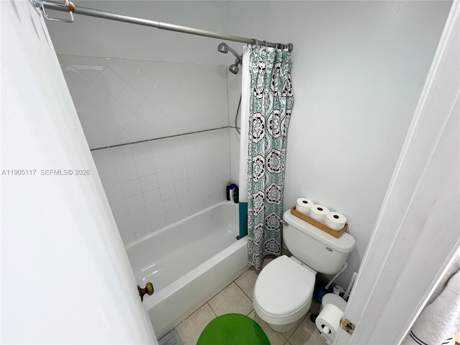 4555 Southwest 68th Ct Circle, Unit 111 Miami, FL 33155 - Photo 21 of 33 a white toilet sitting next to a bath tub