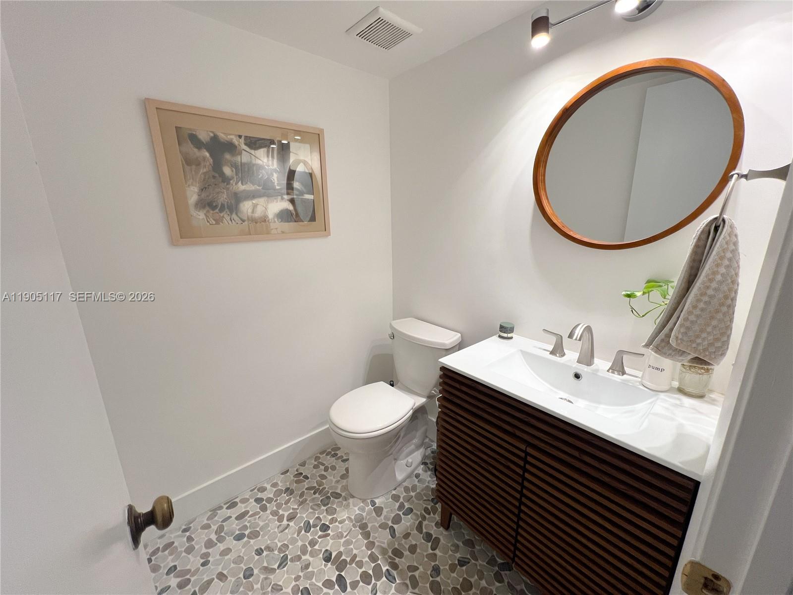 4555 Southwest 68th Ct Circle, Unit 111 Miami, FL 33155 - Photo 22 of 33 a bathroom with a sink and a mirror